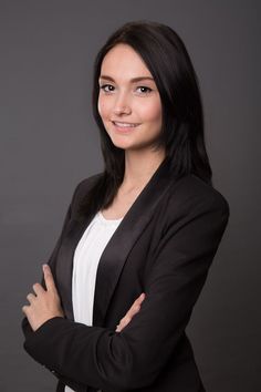 a woman with her arms crossed posing for a photo