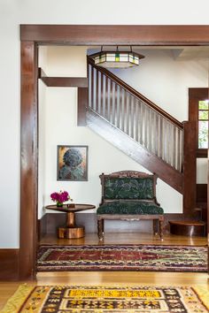 a living room with a stair case next to a couch