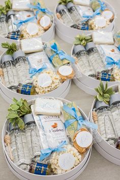 four tins filled with cheese and crackers on top of a table next to each other