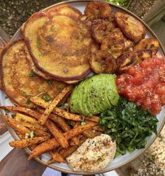 a plate filled with french toast, avocado and other food on top of it