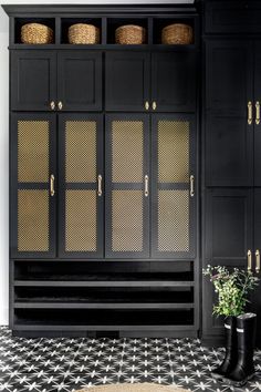 a black and white tiled floor next to a cabinet with baskets on the top shelf