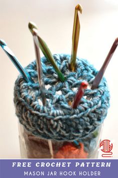 a jar filled with crochet needles and yarn