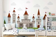 a child's bedroom with a castle mural on the wall and a teddy bear