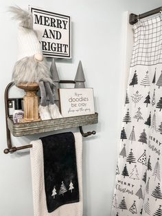 there is a towel rack in the bathroom with towels on it and a stuffed animal