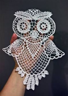 an owl made out of white crochet