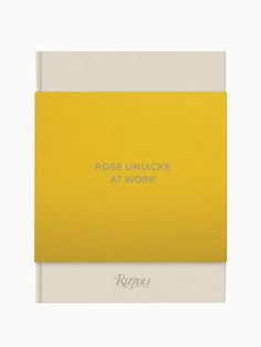 a yellow and white book with the words rose unnacke at work on it