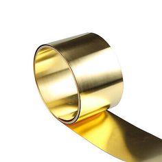 a roll of gold colored tape on a white background