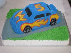 a birthday cake made to look like a race car with flames on the front and sides