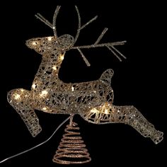 a lighted reindeer ornament hanging from a string