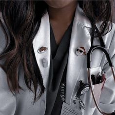 a woman wearing a white lab coat and holding a stethoscope