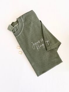 Christian Embroidered Shirts, Long Sleeve Cotton Shirt With Embroidered Text, Embroidered Green Cotton Shirt, Cotton Long Sleeve Shirt With Embroidered Text, Green Embroidered Cotton Shirt, Green Cotton Tops With Machine Embroidery, Cotton Shirt With Custom Embroidery, Short Sleeve, Embroidered Shirt Ideas, Jesus Is King Shirt