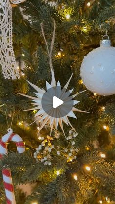 a christmas tree with ornaments on it and an ornament hanging from the top