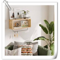 a living room filled with lots of furniture next to a wall mounted potted plant