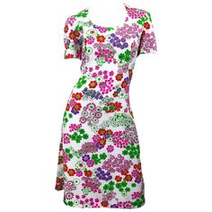 Chic 1960s SAKS 5TH AVENUE silk and cotton short sleeve A-Line dress! Features a stark white background with flowers in vibrant colors of purple, pink, red, and green throughout. Fully lined. Full metal zipper up the back with hook-and-eye closure. Very well made with heavy attention to detail. Great for any day or evening event. Perfect with sandals, wedges, flats, boots or heels. In great condition. Made in USA Approximately Size Medium / Large Measurements: 38-40 inch bust 34 inch waist 46-48 White Background With Flowers, Background With Flowers, Flats Boots, Sandals Wedges, 5th Avenue, Hook And Eye, Full Metal, Back Shoulder, Line Dress