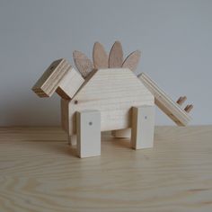 a wooden toy that is shaped like a house