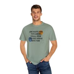 a man standing with his hands in his pockets wearing a t - shirt that says, john waste more