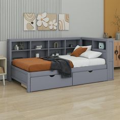 a bed with two storage drawers underneath it and a dresser next to it in a room