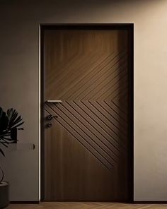 an empty room with a door and potted plant on the floor next to it