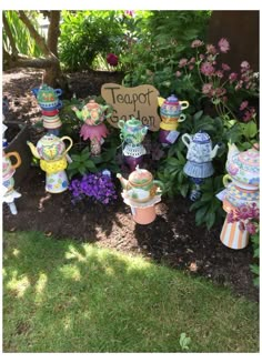 there are many teapots on display in the garden