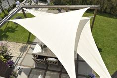 an overhead view of a patio with tables and chairs under a large white awning