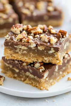 three pieces of chocolate pecan bars stacked on top of each other