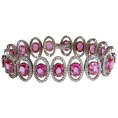 Posh Pinks & Halo. 23.35ct. Natural Pink Sapphires & 4.12ct Diamonds bracelet. Full Oval cuts, great sparkle. Average Each: 6 X 8mm Clean Clarity & Transparent. Vivid Pinks and Prime Saturation. Round Brilliant Diamonds: G-color Vs-2 clarity. Secure pressure clasp and safety catch. 28.6 grams. 14kt. Rose & White Gold. Measures 7 inches (wearable length) 16mm wide. $42,000 Appraisal Certificate to accompany Formal Pink Diamond Bracelet With 17 Jewels, Halo Logo, Bracelets Tennis, Brooch Diamond, Pink Halo, Diamonds Bracelet, Flexible Bracelet, Bracelet Tennis, Vintage Tennis