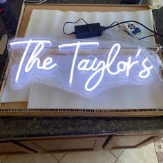 a sign that says the taylor's on it in front of a counter top