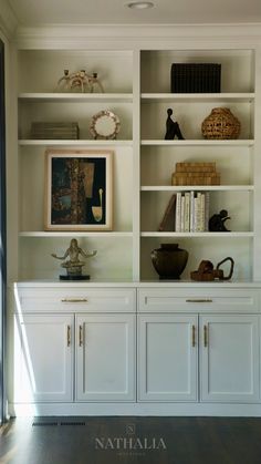 a white bookcase filled with lots of books