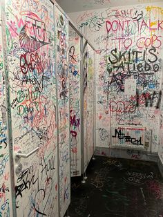 graffiti covered walls and stalls in a public restroom