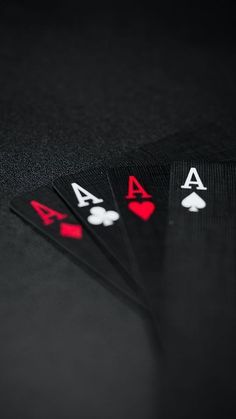 four playing cards sitting on top of each other