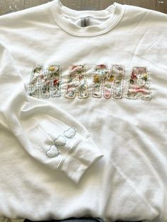 a white shirt with the word mama on it