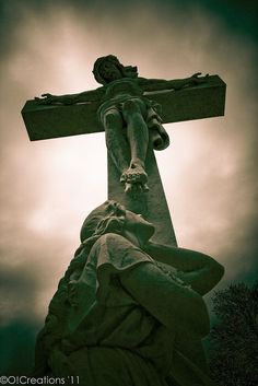 a statue of jesus on top of a cross