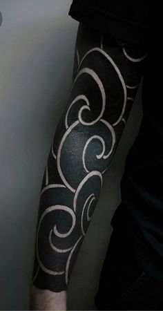 a man with a black and white tattoo on his arm