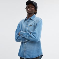 Based on traditional workwear styles this relaxed-fit cotton denim shirt is a go-with-everything staple. The classic button-down design is finished with a pointed collar and chest pocket detailed with our Coach label for a subtle heritage touch. Luxury Medium Wash Denim Shirt, Unstructured Indigo Denim Shirt, Washed Blue Relaxed Fit Button-up Denim Top, Denim Blue Relaxed Fit Button-up Blouse, Sling Bag Mini, Unstructured Denim Button-up Shirt, Coach Outlet, Workwear Fashion, Pocket Detail