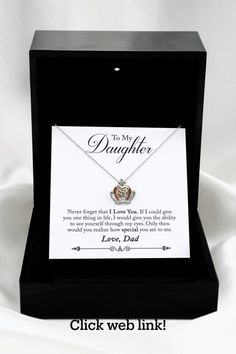 a necklace in a black box with a poem on it that says to my daughter