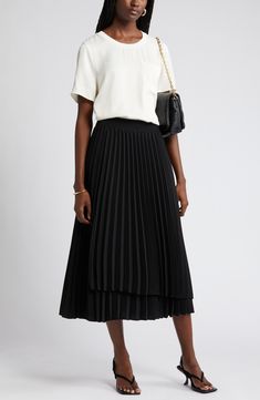 An elastic waist tops this flowy midi-length skirt accented with a layered design, asymmetric hem and easy-moving pleats. Elastic waist 100% polyester Dry clean Imported Solid Flowy Midi Pleated Skirt, Pleated Skirt Outfit Wedding, Black Pleated Skirt Outfit Summer, Pleated Skirt Outfit Summer, Non-stretch Midi Pleated Skirt, Black Pleated Skirt Outfit, Pleated Midi Skirt Outfit, Relaxed Midi-length Lined Pleated Skirt, Flowy Midi-length Pleated Skirt With Box Pleat