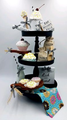 three tiered cupcake display with decorative items