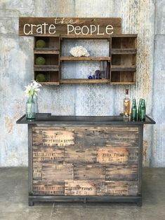 an old wooden crate with some bottles on it and a sign that says crate people