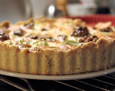 a close up of a pie on a plate in an oven with other food items