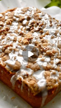 a close up of a piece of food on a paper towel with white icing