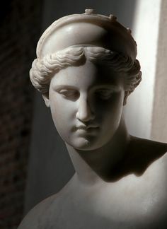 a statue of a woman's head with her eyes closed