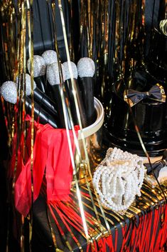 a table topped with black and gold decorations