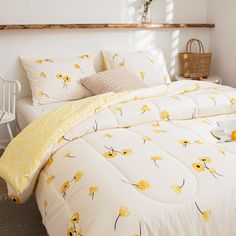 a white bed with yellow flowers on it