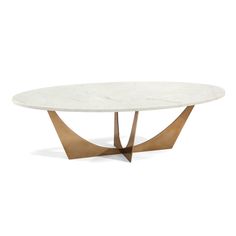 an oval marble table with gold metal legs