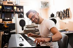 a man playing the piano in his home studio