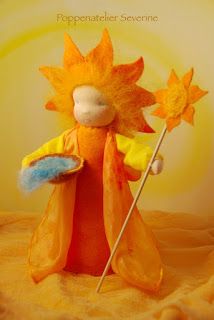 a stuffed toy with a yellow dress and orange hat