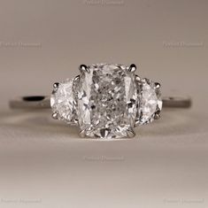 three stone engagement ring with an oval cut diamond