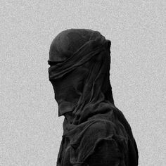 a black and white photo of a person wearing a veil on top of their head