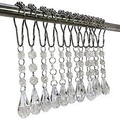 a metal curtain with lots of crystal drops hanging from it's hooks and chains