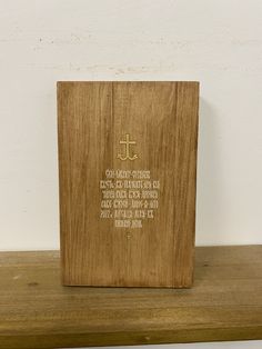 a wooden plaque with an inscription on it